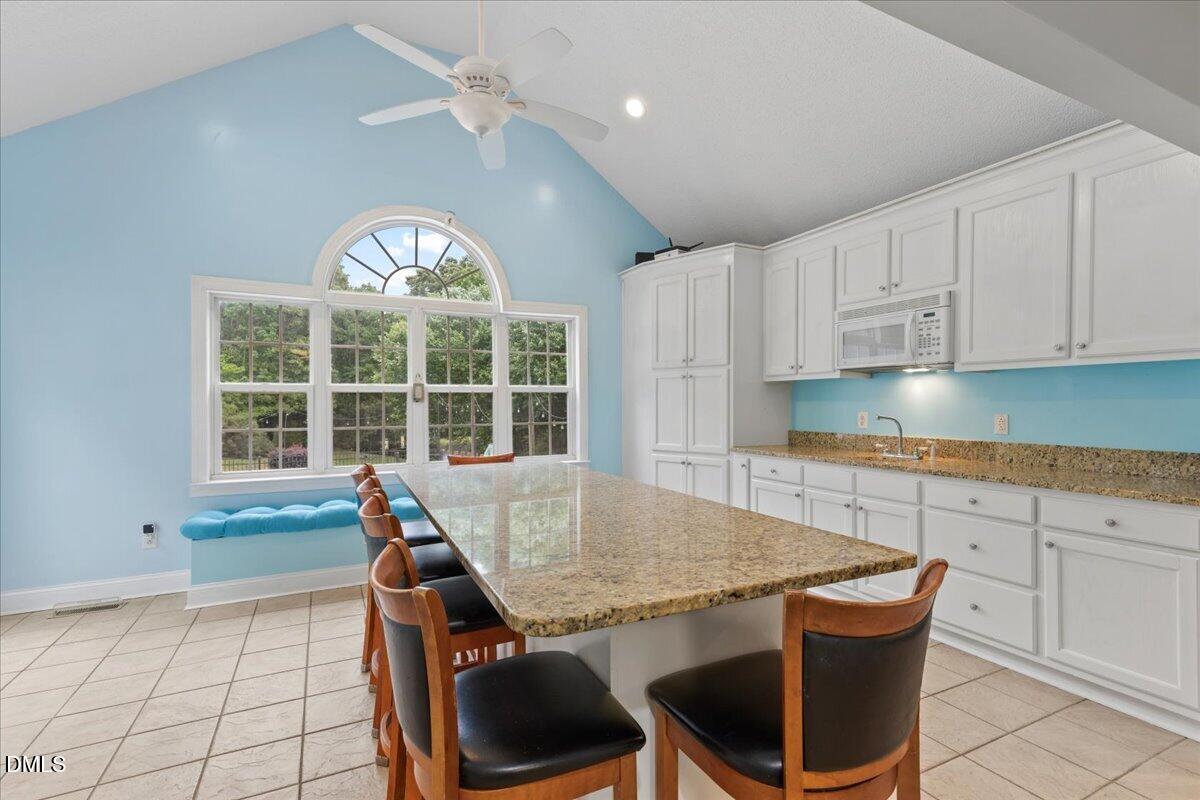 4317 South Mountain Drive Raleigh, NC 27603 - Photo 11 of 57 a kitchen with a table chairs and cabinets