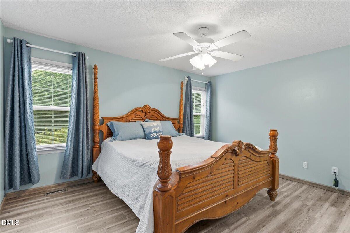4317 South Mountain Drive Raleigh, NC 27603 - Photo 20 of 57 a bedroom with a bed and window