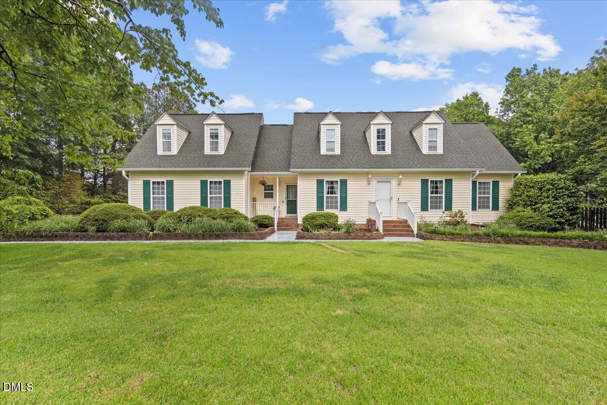 4317 South Mountain Drive Raleigh, NC 27603 - Photo 2 of 57 a front view of a house with a garden
