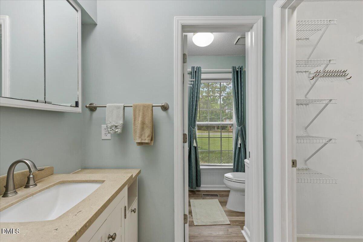 4317 South Mountain Drive Raleigh, NC 27603 - Photo 22 of 57 a bathroom with a sink toilet and tub