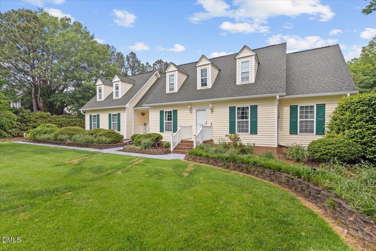 4317 South Mountain Drive Raleigh, NC 27603 - Photo 3 of 57 a front view of a house with a garden