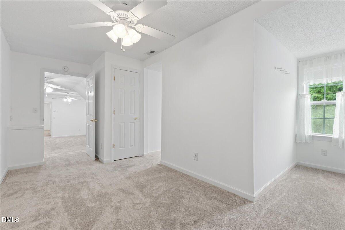 4317 South Mountain Drive Raleigh, NC 27603 - Photo 31 of 57 an empty room with fan and a ceiling fan