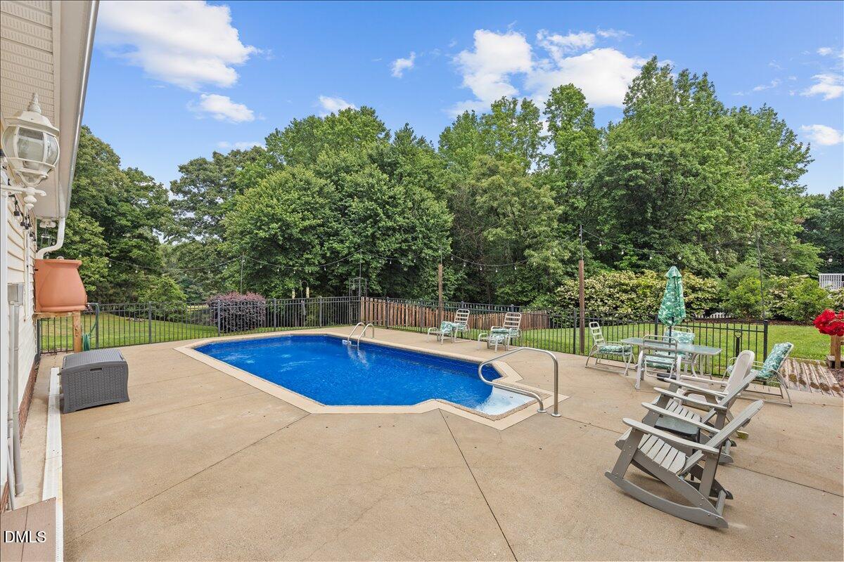 4317 South Mountain Drive Raleigh, NC 27603 - Photo 33 of 57 a view of a swimming pool with a patio