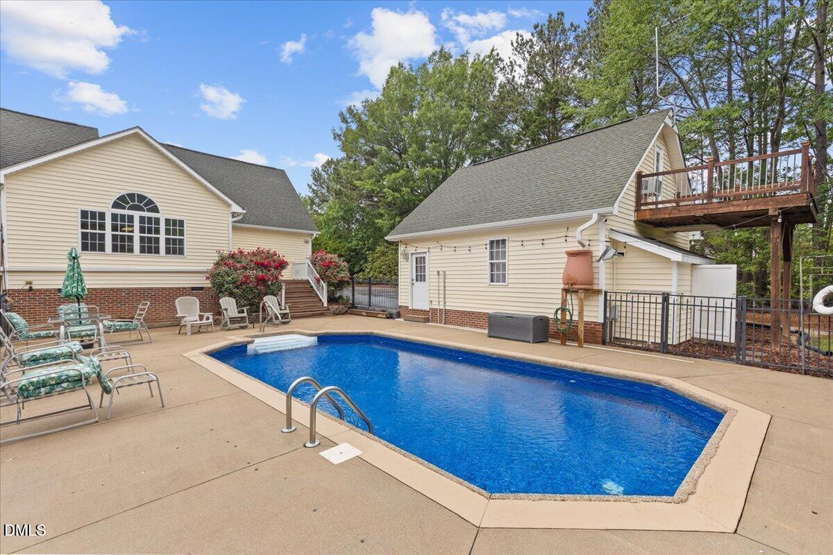 4317 South Mountain Drive Raleigh, NC 27603 - Photo 34 of 57 a view of house with swimming pool yard and outdoor seating
