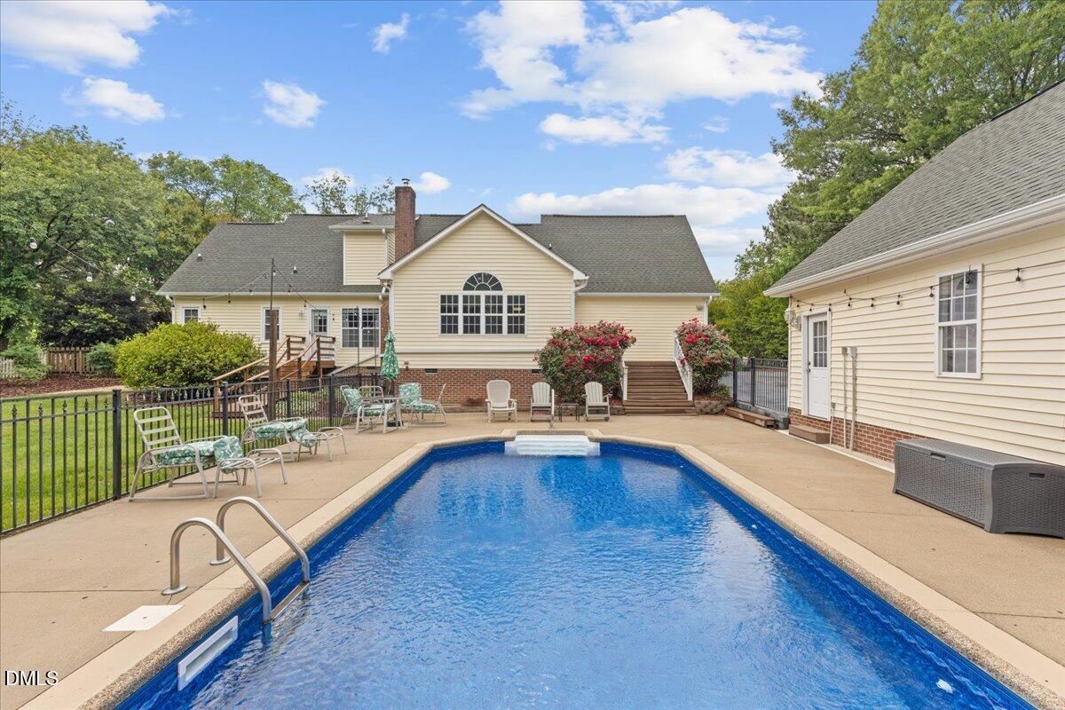 4317 South Mountain Drive Raleigh, NC 27603 - Photo 35 of 57 a view of a house with swimming pool and sitting area