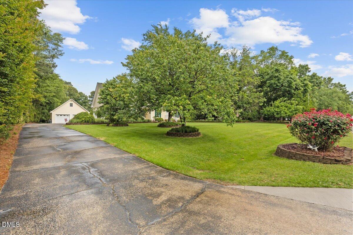 4317 South Mountain Drive Raleigh, NC 27603 - Photo 4 of 57 a view of a garden with a fountain