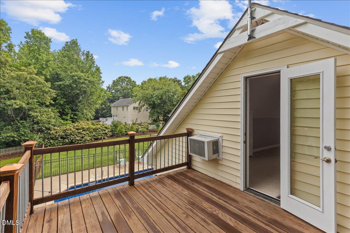 4317 South Mountain Drive Raleigh, NC 27603 - Photo 43 of 57 a view of a wooden balcony with an outdoor space