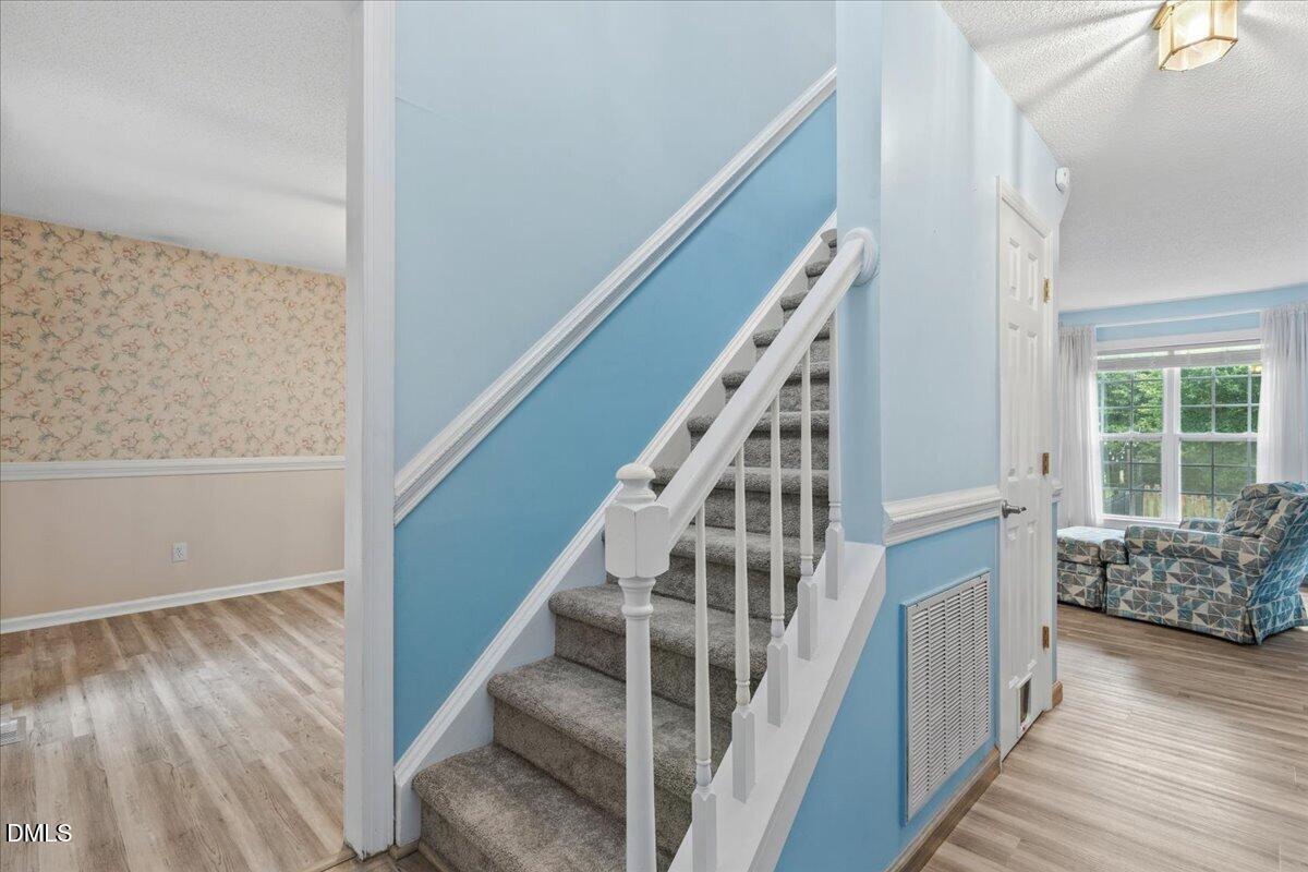 4317 South Mountain Drive Raleigh, NC 27603 - Photo 5 of 57 a view of entryway and hall with wooden floor