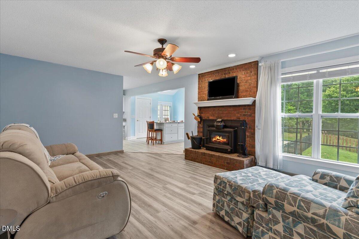 4317 South Mountain Drive Raleigh, NC 27603 - Photo 7 of 57 a bedroom with a bed and a fireplace