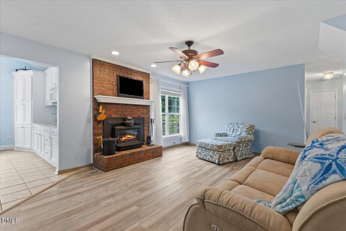 4317 South Mountain Drive Raleigh, NC 27603 - Photo 8 of 57 a living room with furniture and a fireplace
