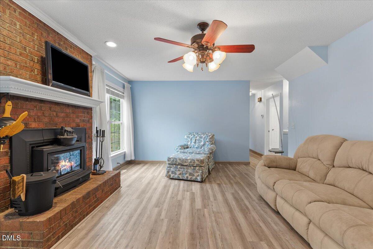 4317 South Mountain Drive Raleigh, NC 27603 - Photo 9 of 57 a living room with furniture fireplace and flat screen tv