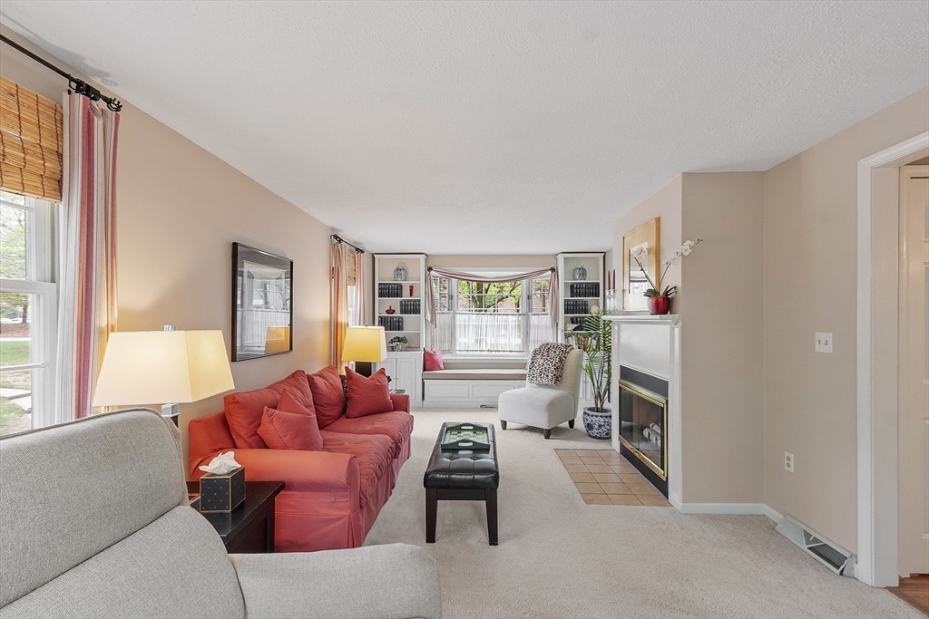 187 Turnpike Road, Unit 187 Chelmsford, MA 01824 - Photo 11 of 42 a living room with furniture and a fireplace