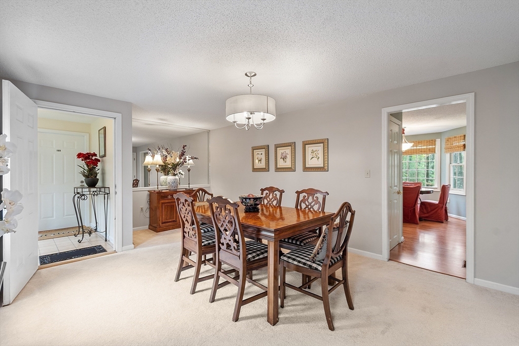 187 Turnpike Road, Unit 187 Chelmsford, MA 01824 - Photo 13 of 42 a view of a dining room with furniture and a chandelier