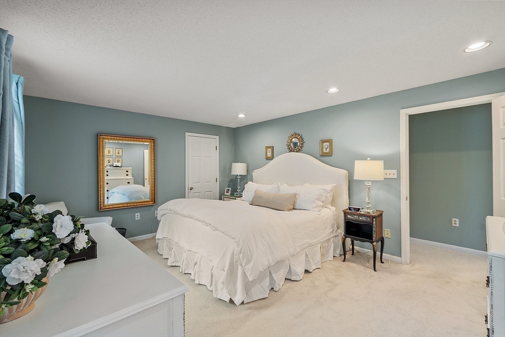 187 Turnpike Road, Unit 187 Chelmsford, MA 01824 - Photo 18 of 42 a bedroom with a bed and a potted plant