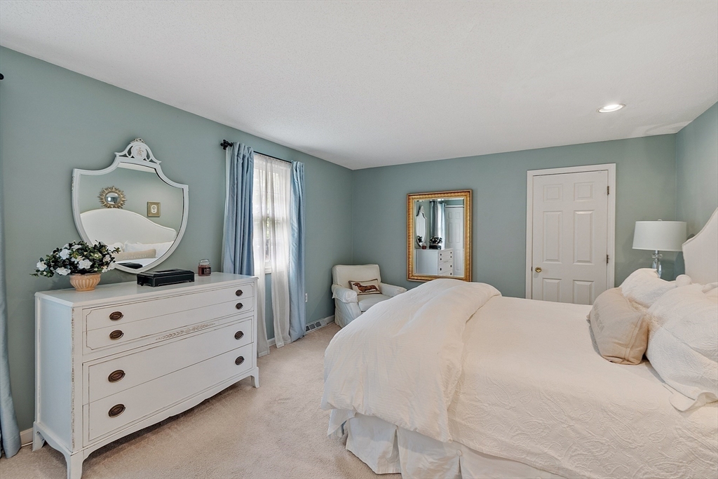187 Turnpike Road, Unit 187 Chelmsford, MA 01824 - Photo 19 of 42 a bedroom with a bed and a dresser