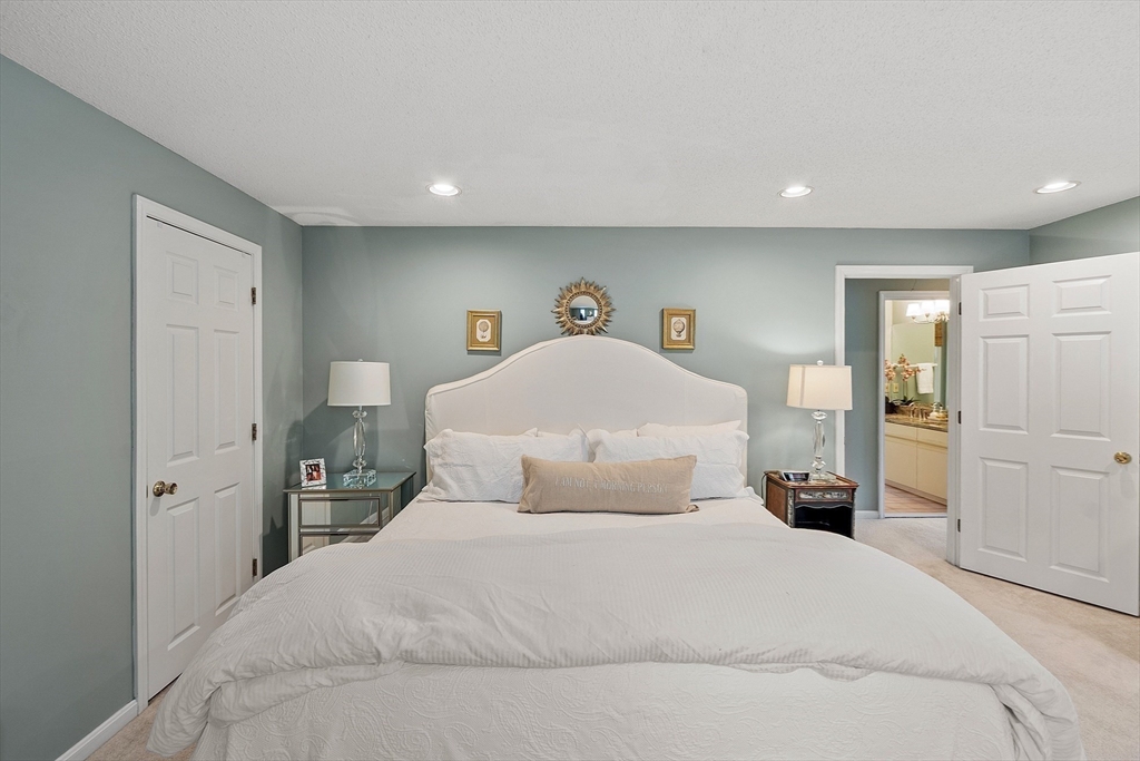 187 Turnpike Road, Unit 187 Chelmsford, MA 01824 - Photo 20 of 42 a bedroom with a bed and a night stand