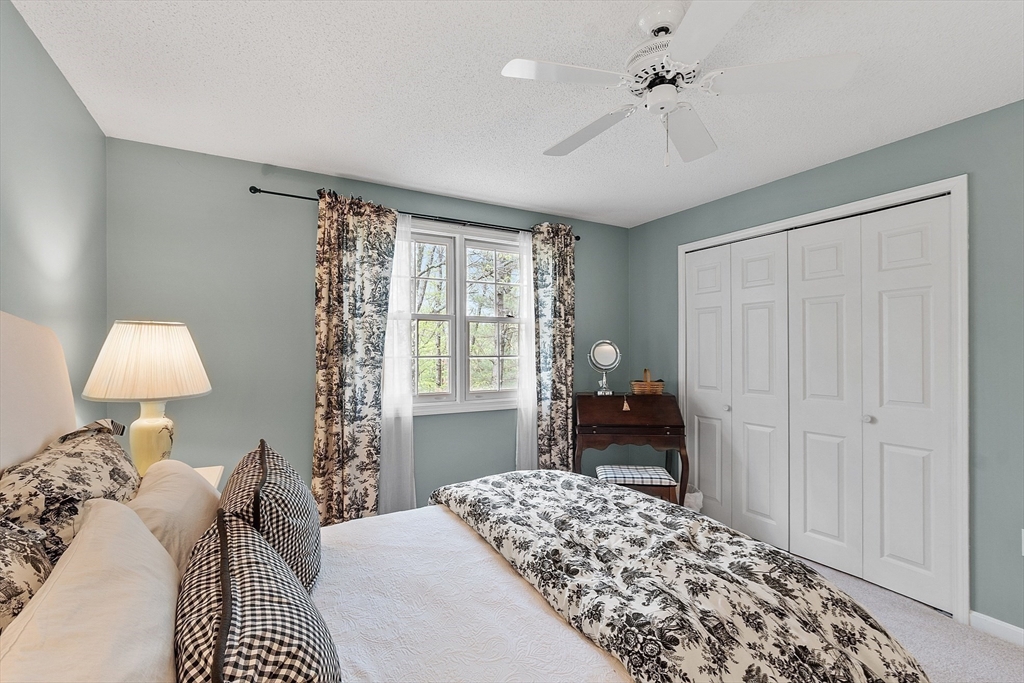 187 Turnpike Road, Unit 187 Chelmsford, MA 01824 - Photo 22 of 42 a bedroom with a bed and a lamp