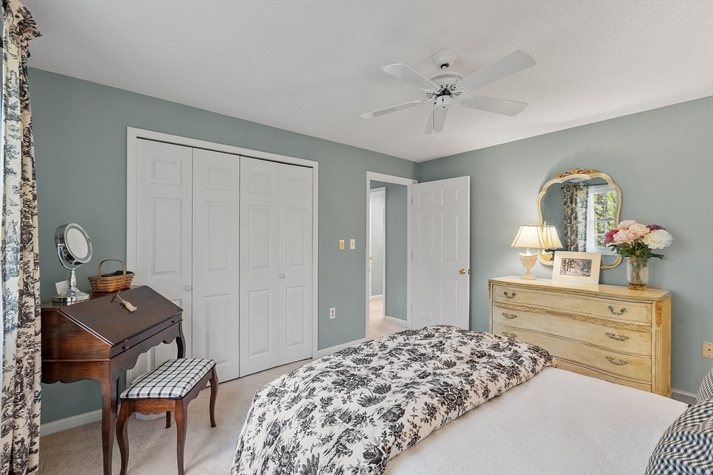 187 Turnpike Road, Unit 187 Chelmsford, MA 01824 - Photo 23 of 42 a bed room with a bed and a dresser