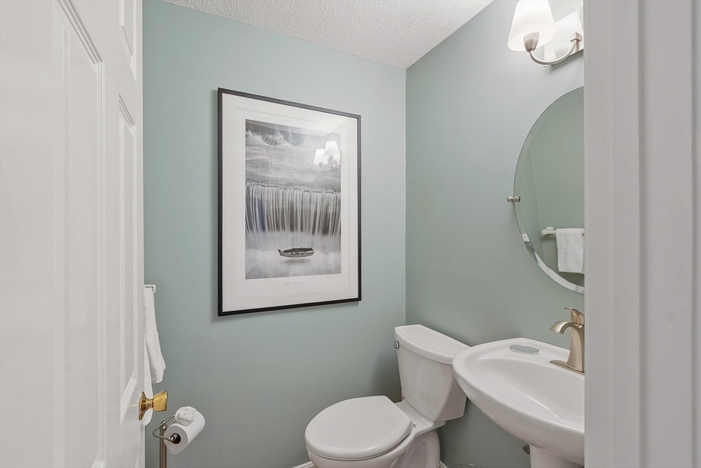 187 Turnpike Road, Unit 187 Chelmsford, MA 01824 - Photo 29 of 42 a bathroom with a toilet a sink and mirror