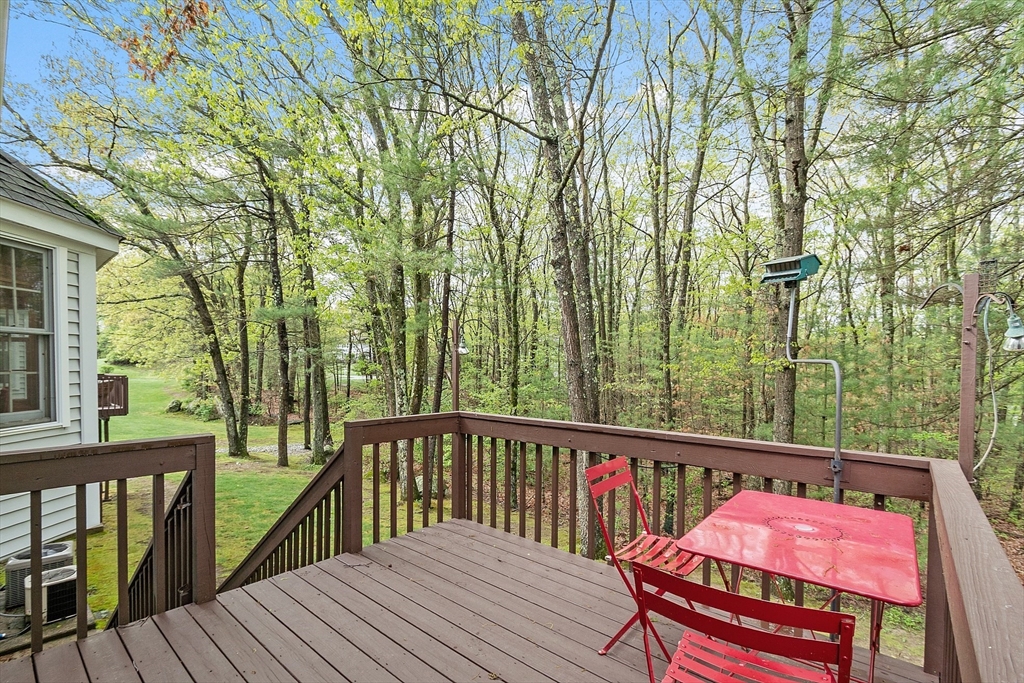 187 Turnpike Road, Unit 187 Chelmsford, MA 01824 - Photo 35 of 42 a view of balcony with wooden floor and outdoor seating