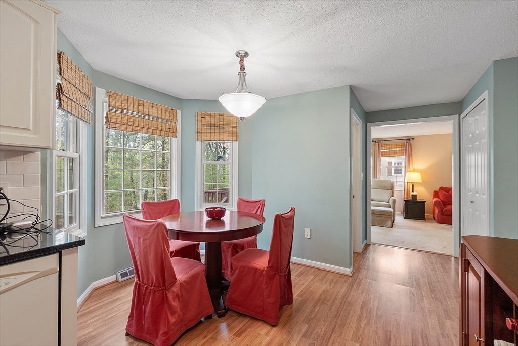 187 Turnpike Road, Unit 187 Chelmsford, MA 01824 - Photo 5 of 42 a view of a dining room with furniture window and wooden floor