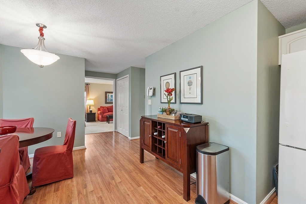 187 Turnpike Road, Unit 187 Chelmsford, MA 01824 - Photo 7 of 42 a living room with furniture and a wooden floor
