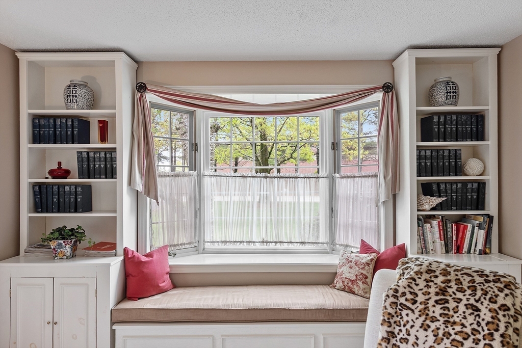 187 Turnpike Road, Unit 187 Chelmsford, MA 01824 - Photo 10 of 42 a living room with furniture and a floor to ceiling window