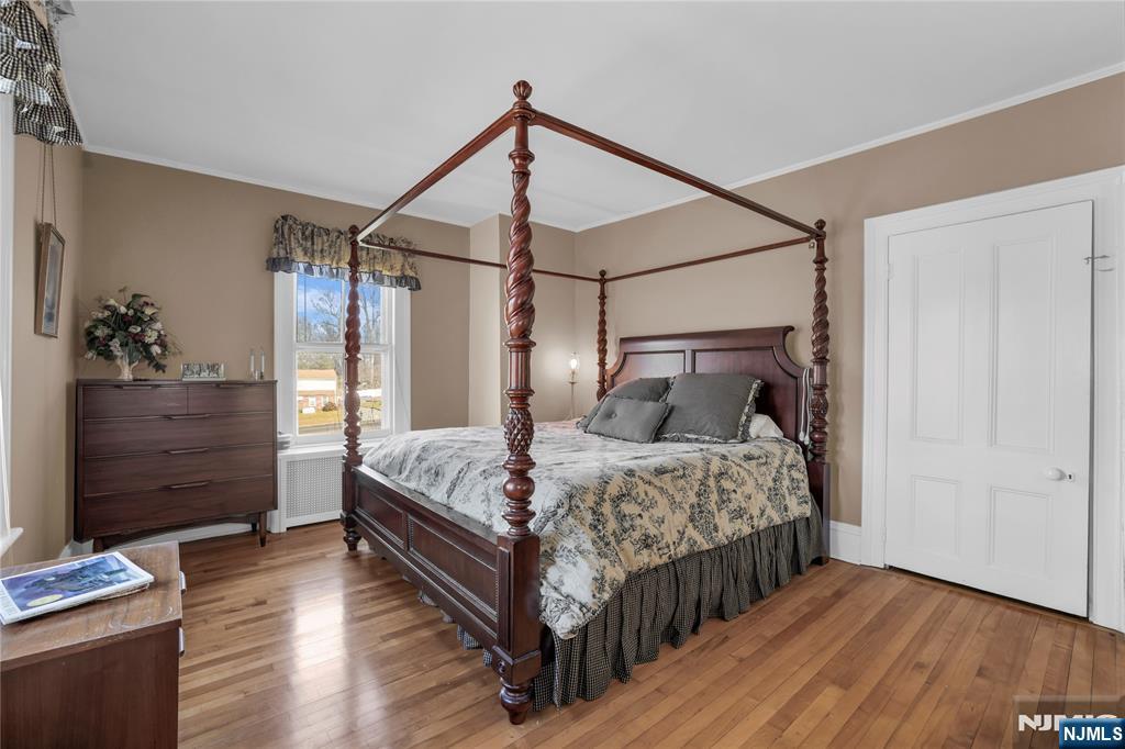 265 Little Falls Road Cedar Grove, NJ 07009 - Photo 30 of 49 a bedroom with a bed and wooden floor