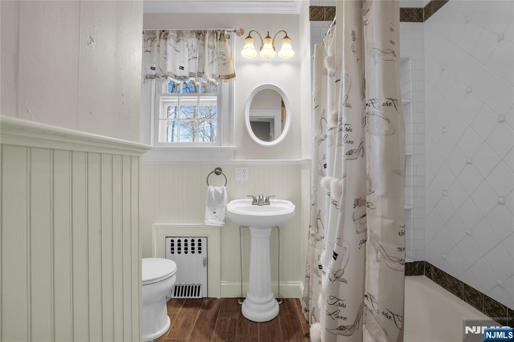 265 Little Falls Road Cedar Grove, NJ 07009 - Photo 36 of 49 a bathroom with a toilet sink and mirror