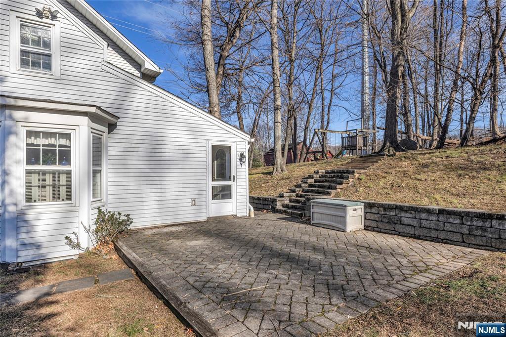 265 Little Falls Road Cedar Grove, NJ 07009 - Photo 39 of 49 a view of a house with a yard covered in snow