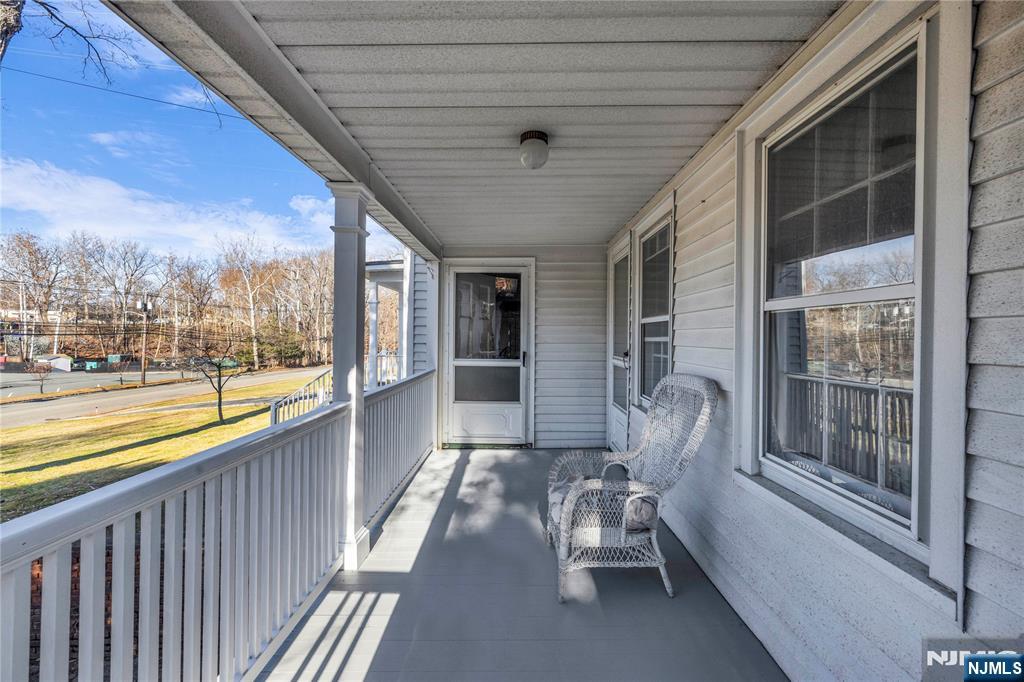265 Little Falls Road Cedar Grove, NJ 07009 - Photo 7 of 49 a porch with chairs next to a yard
