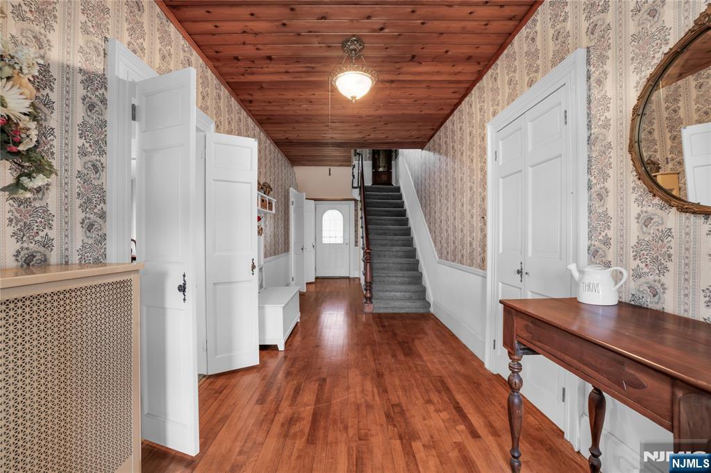 265 Little Falls Road Cedar Grove, NJ 07009 - Photo 10 of 49 a view of a hallway with wooden floor and staircase