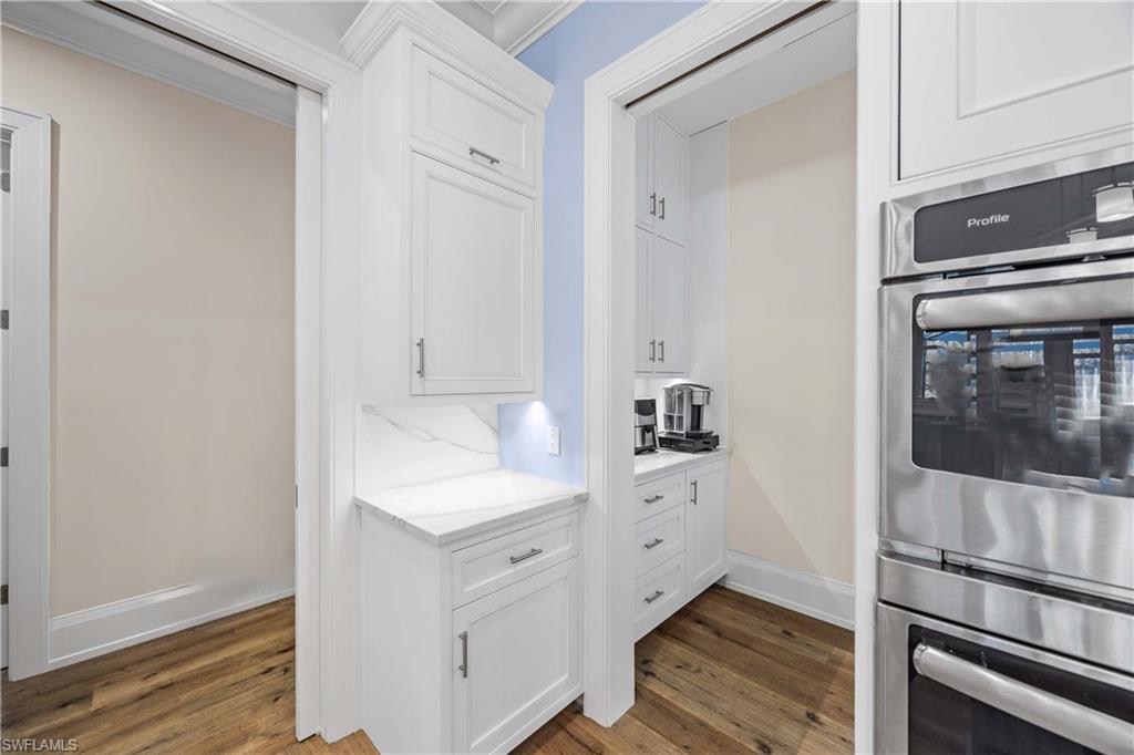 4885 Tamarind Ridge Drive Naples, FL 34119 - Photo 11 of 39 a kitchen with a sink and cabinets