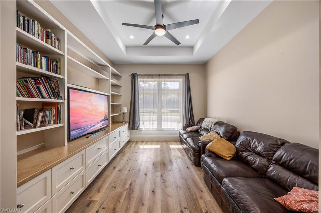 4885 Tamarind Ridge Drive Naples, FL 34119 - Photo 14 of 39 a living room with furniture and a flat screen tv