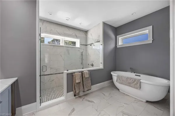 a bathroom with a bathtub and shower