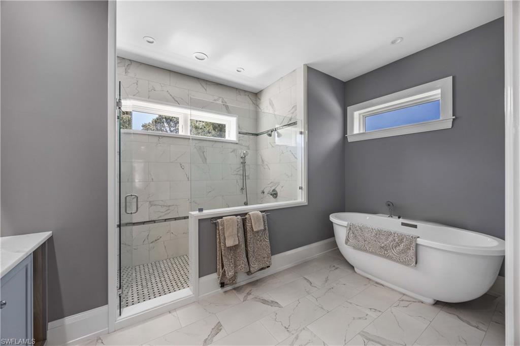 4885 Tamarind Ridge Drive Naples, FL 34119 - Photo 17 of 39 a bathroom with a bathtub and shower