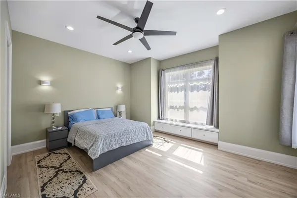 a bedroom with a large bed and a large window