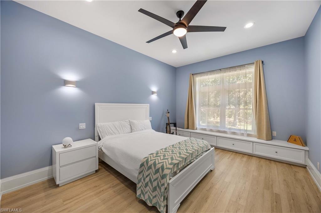 4885 Tamarind Ridge Drive Naples, FL 34119 - Photo 22 of 39 a bedroom with a bed and a ceiling fan
