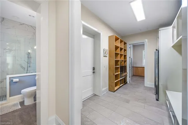 a view of an empty room and a bathroom