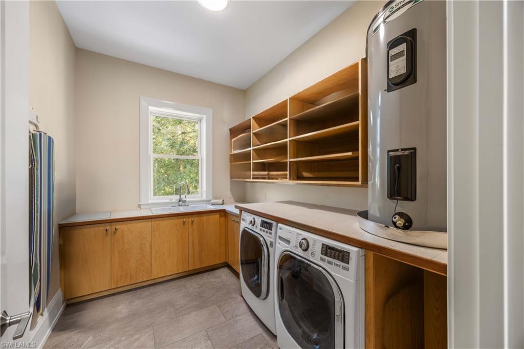 4885 Tamarind Ridge Drive Naples, FL 34119 - Photo 28 of 39 a view of a kitchen with washer and dryer