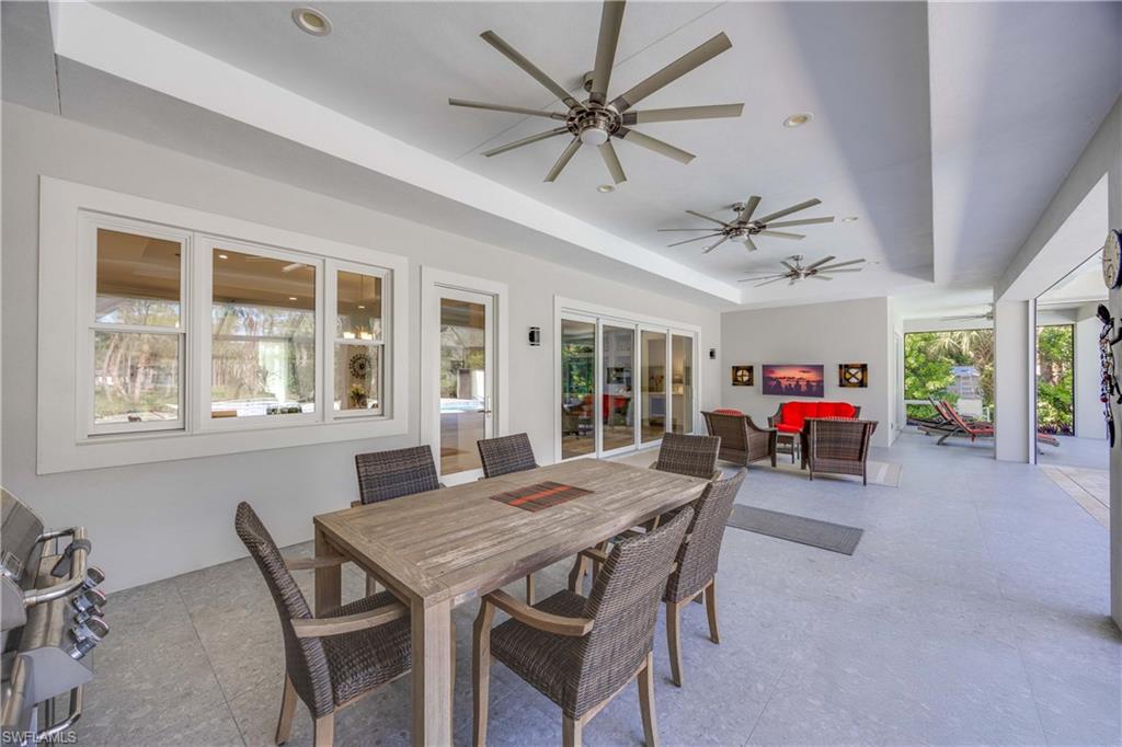 4885 Tamarind Ridge Drive Naples, FL 34119 - Photo 32 of 39 a view of a dining room with furniture window and wooden floor