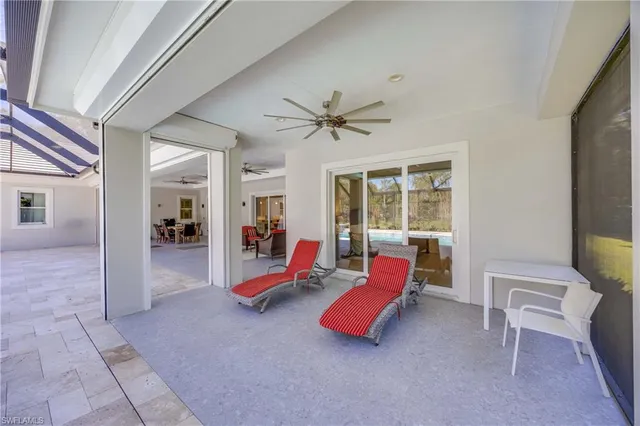 a living room with furniture pool table and a large window