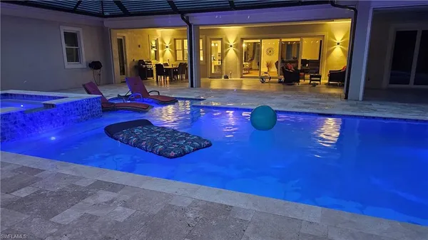 a living room with couch dining table and large windows