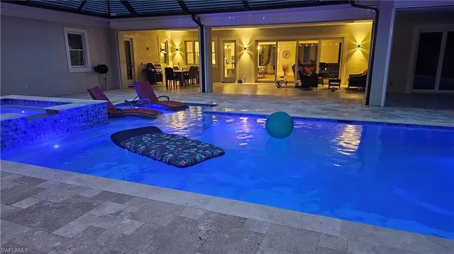 a living room with couch dining table and large windows