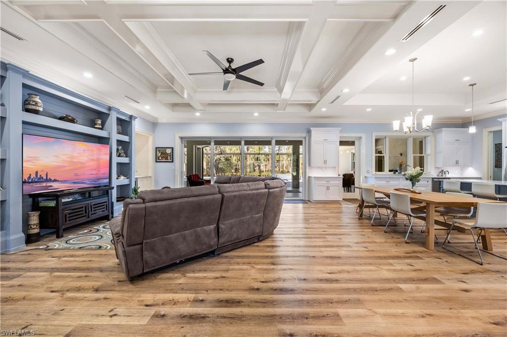 4885 Tamarind Ridge Drive Naples, FL 34119 - Photo 6 of 39 a living room with furniture and a flat screen tv