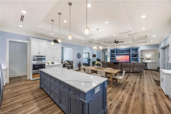 a large kitchen with a table and chairs in it