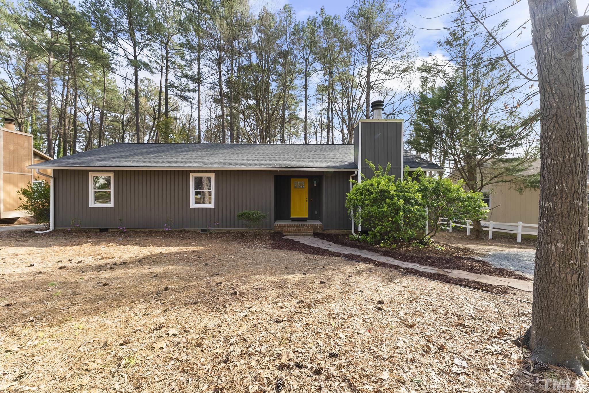 a view of a house with a yard and garage
