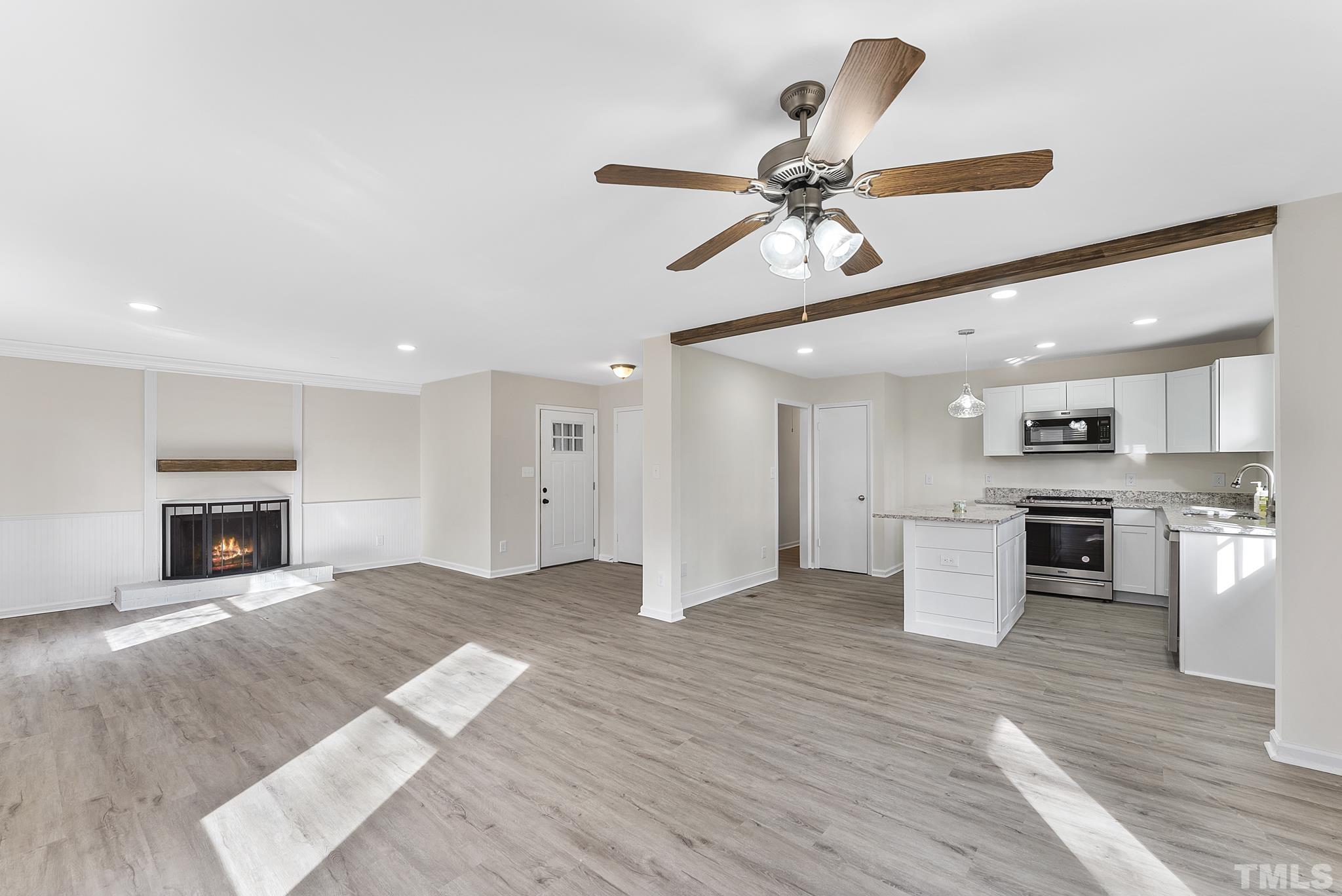 2125 Strebor Street Durham, NC 27705 - Photo 13 of 38 a view of kitchen and hall with wooden floor