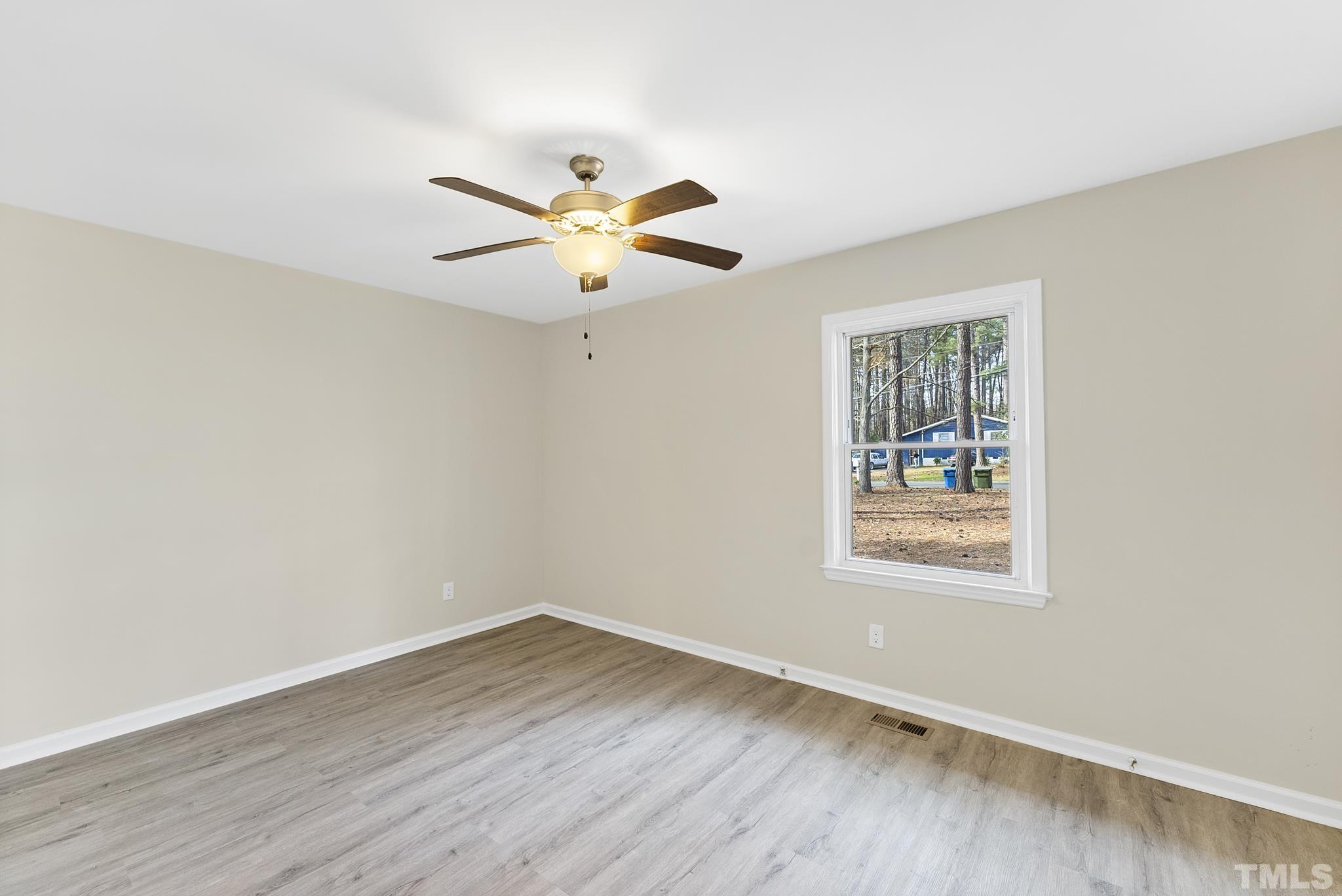 2125 Strebor Street Durham, NC 27705 - Photo 19 of 38 an empty room with wooden floor and windows