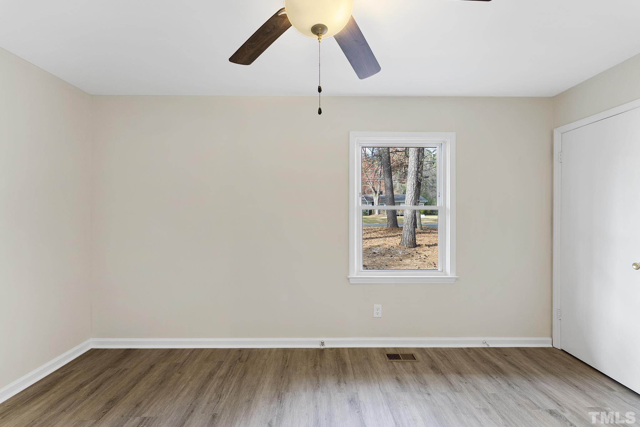 2125 Strebor Street Durham, NC 27705 - Photo 20 of 38 a view of an empty room with wooden floor and a window